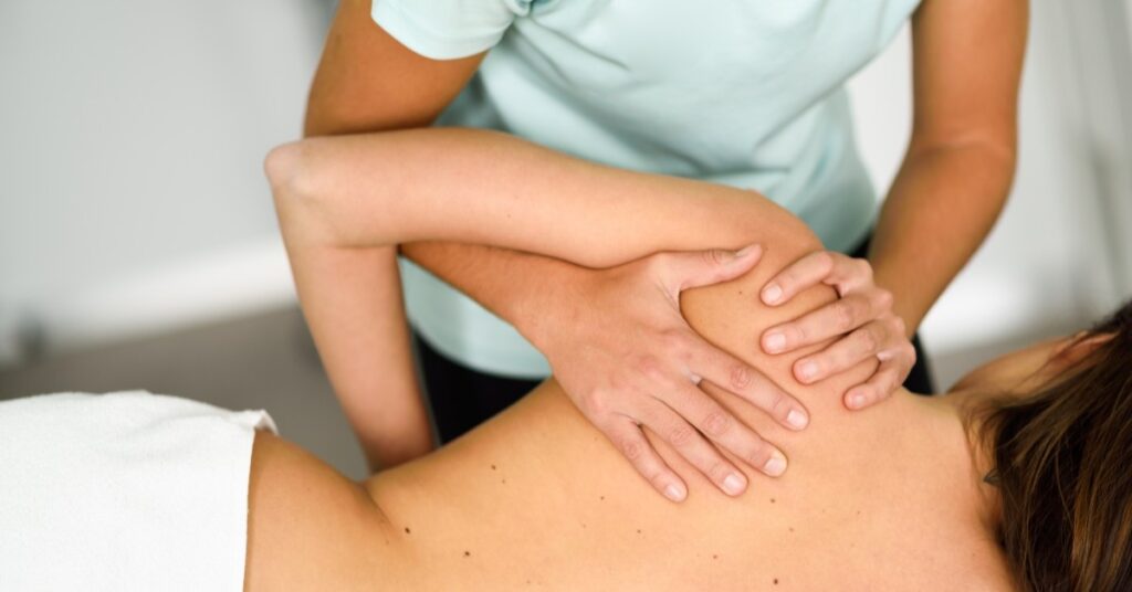 Chiropractor giving a patient a massage.