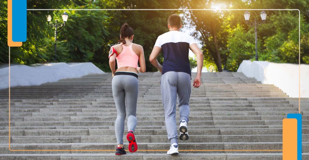 2 people running up stairs outside