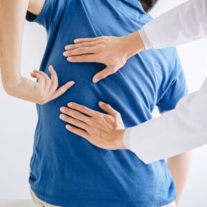 person pointing at their back