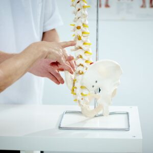 person pointing at a spine