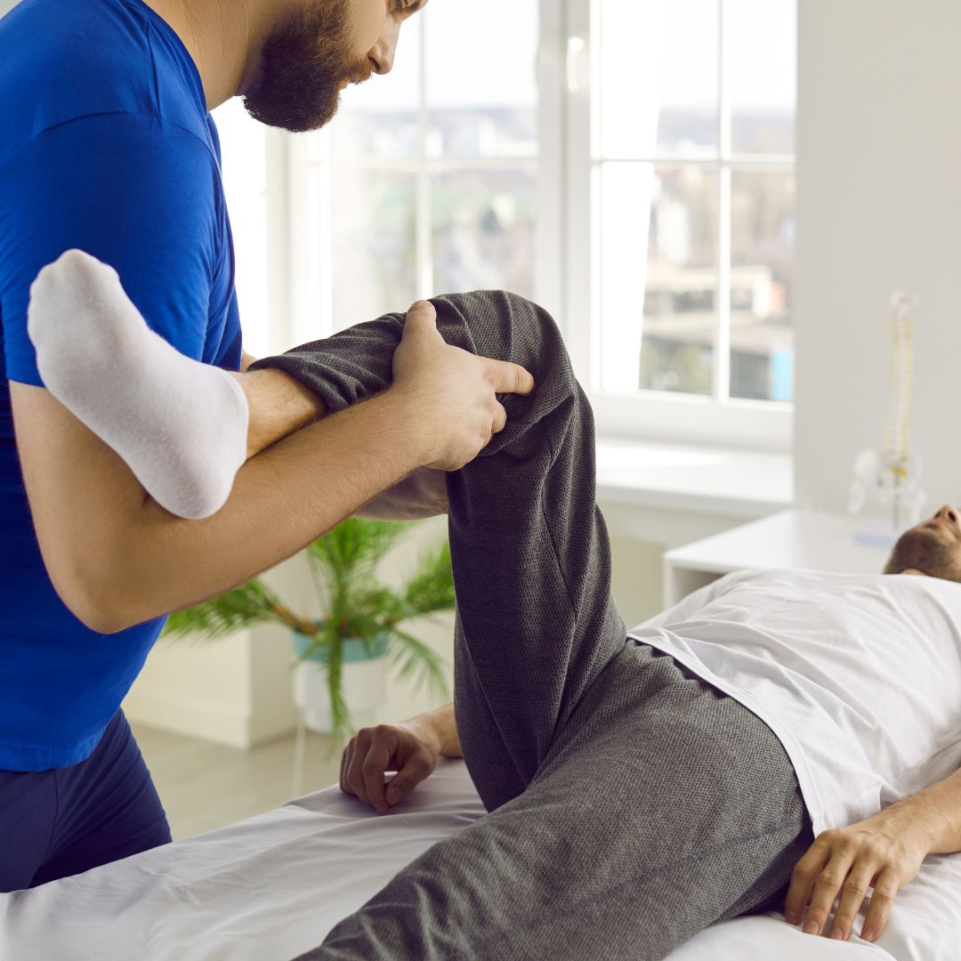 Chiropractor helping patient with rehabilitation stretches
