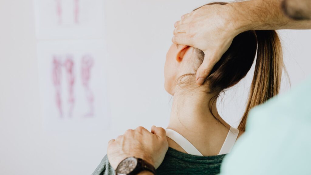 Chiropractor adjusting woman's neck